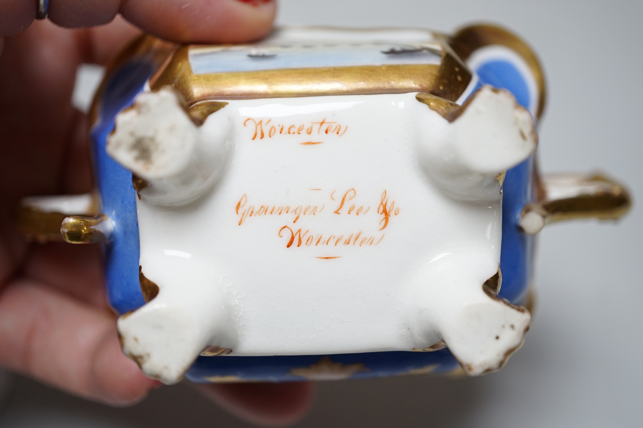 A Grainger Lee and co. miniature pot pourri vase with pierced cover, decorated with a view of Worcester Cathedral and the River Severn, on a blue ground, with two scroll handles and four paw feet and a Coalbrookdale flor